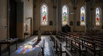 Interior of Catholic cathedral in Cuba with light streaming through stained glass