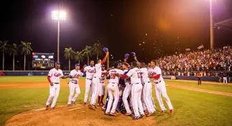 Cuban baseball team celebrating a dramatic victory under stadium lights