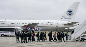 ICE deportation aircraft with Cuban migrants being escorted by federal agents