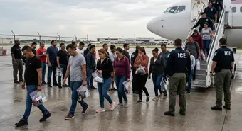 Cuban migrants boarding ICE deportation flight, somber atmosphere in 2026