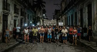 Cubans protesting with pots on a dark street in Havana during a massive blackout