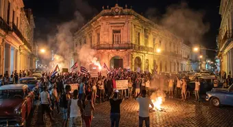 Nighttime protests in Morón in front of government building with smoke