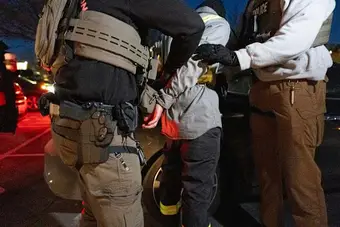 ICE agents during an arrest operation, representing inconsistencies in deportation data reported by DHS