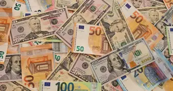 Cuban peso banknotes and digital currency representation