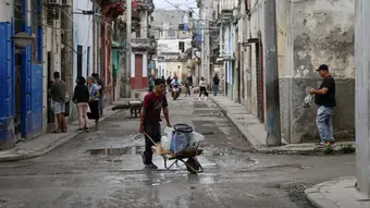 People gathering around a water tanker truck in Havana to collect water during the energy crisis
