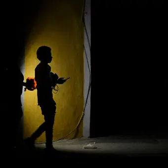 Image showing Cuba's energy crisis with prolonged blackouts and families waiting with water containers