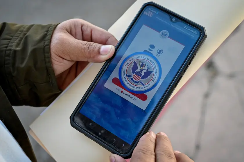 Migrant uses CBP One app on mobile phone