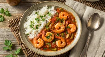 Plate of Cuban shrimp enchilado with white rice and fresh parsley