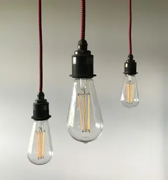 Minimalist hanging lightbulbs evoking González-Torres' light installations. Photo: Pexels