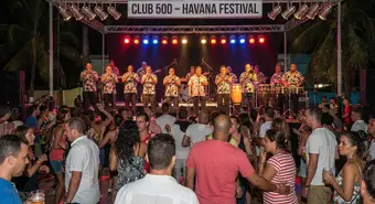 Cuban salsa musicians performing on a festive stage in Havana. AI-generated illustration.