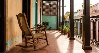 Traditional Cuban rocking chair on a colonial Havana porch. AI-generated illustration.